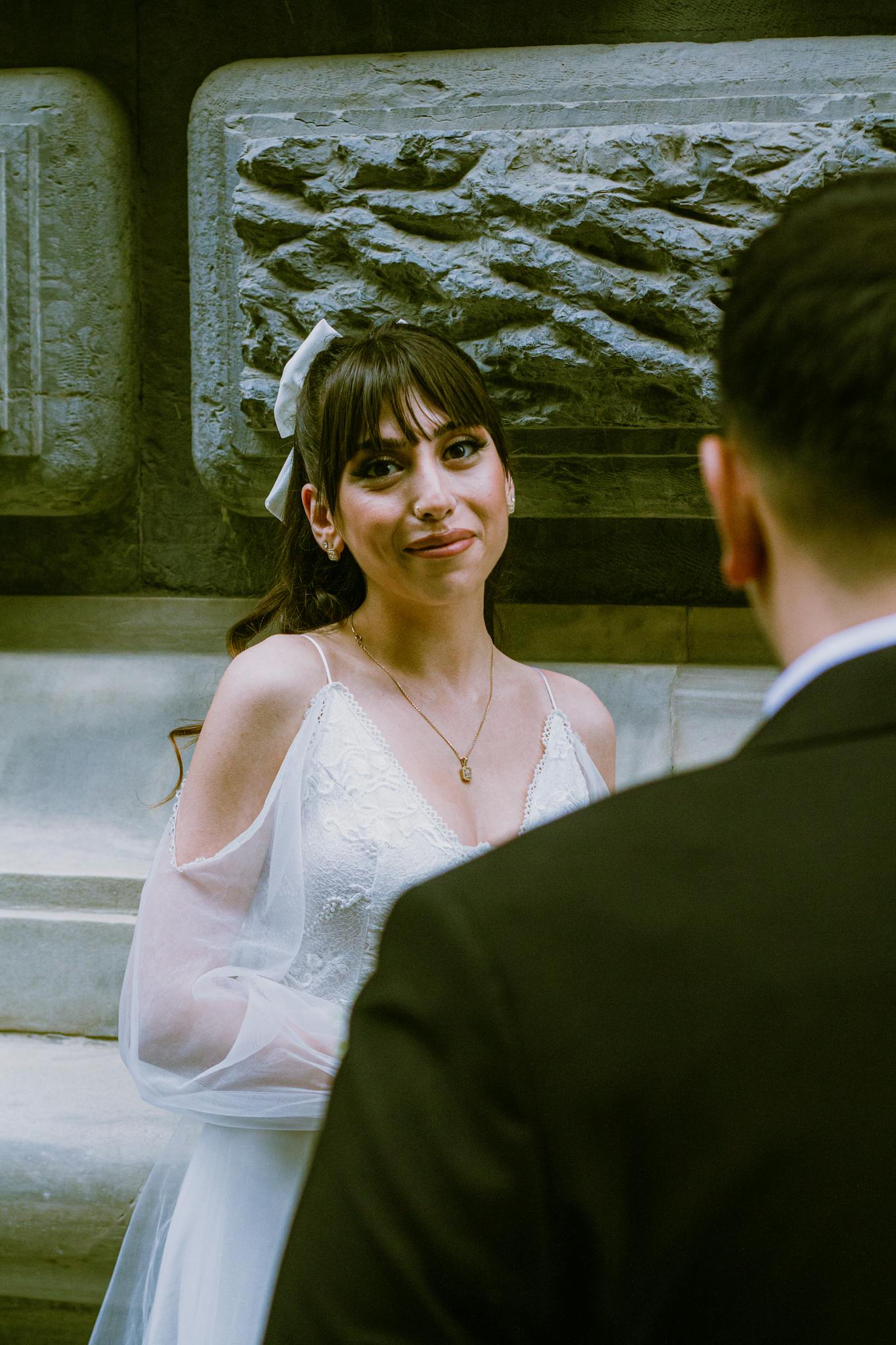 Bride and groom sharing a tender moment during an outdoor wedding ceremony.